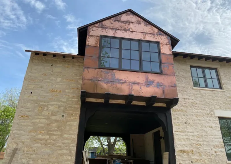 Copper metal panel facade on a stone building for Skylight Installation in Monroe